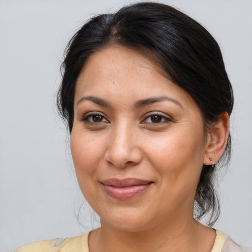 Joyful latino adult female with medium  brown hair and brown eyes