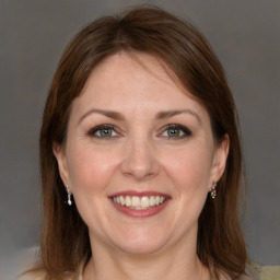 Joyful white adult female with medium  brown hair and grey eyes