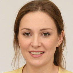 Joyful white young-adult female with medium  brown hair and green eyes