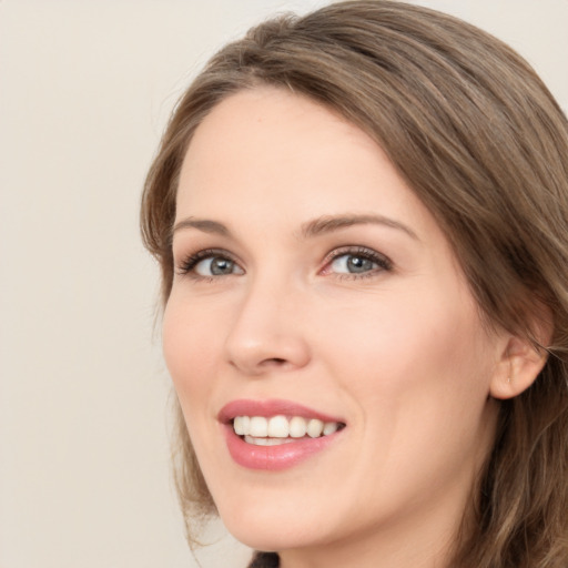 Joyful white young-adult female with medium  brown hair and green eyes