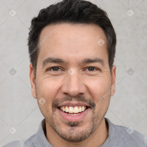 Joyful white young-adult male with short  black hair and brown eyes