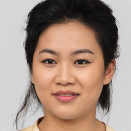 Joyful asian young-adult female with medium  brown hair and brown eyes