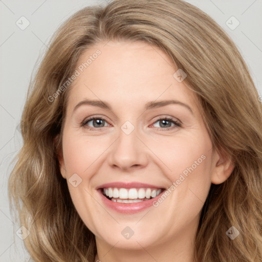 Joyful white young-adult female with long  brown hair and green eyes