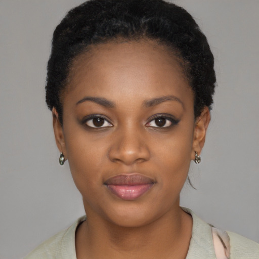 Joyful black young-adult female with short  black hair and brown eyes