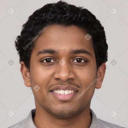 Joyful black young-adult male with short  black hair and brown eyes