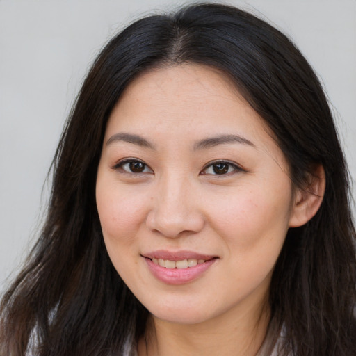 Joyful asian young-adult female with long  brown hair and brown eyes