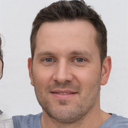 Joyful white young-adult male with short  brown hair and brown eyes