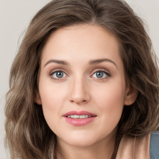 Joyful white young-adult female with medium  brown hair and green eyes