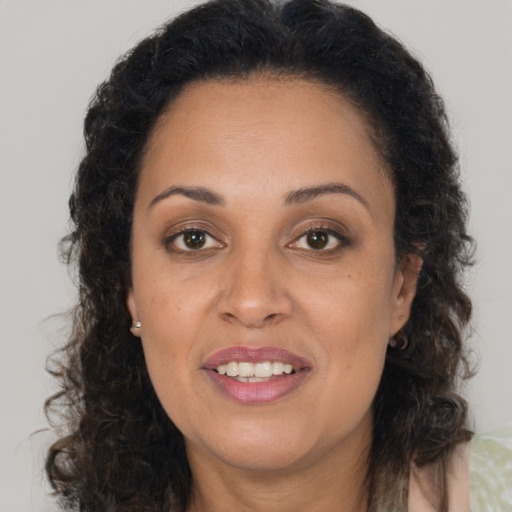 Joyful latino adult female with long  brown hair and brown eyes