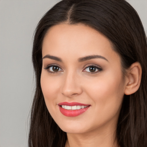 Joyful white young-adult female with long  brown hair and brown eyes