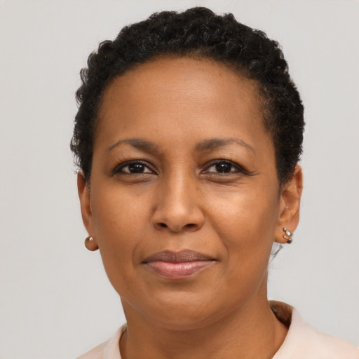 Joyful black adult female with short  brown hair and brown eyes