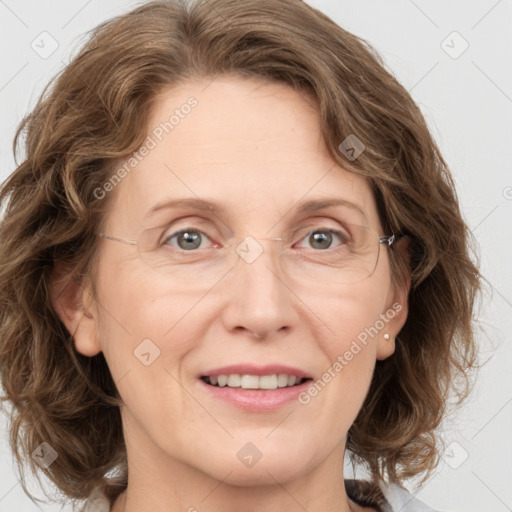 Joyful white adult female with medium  brown hair and blue eyes