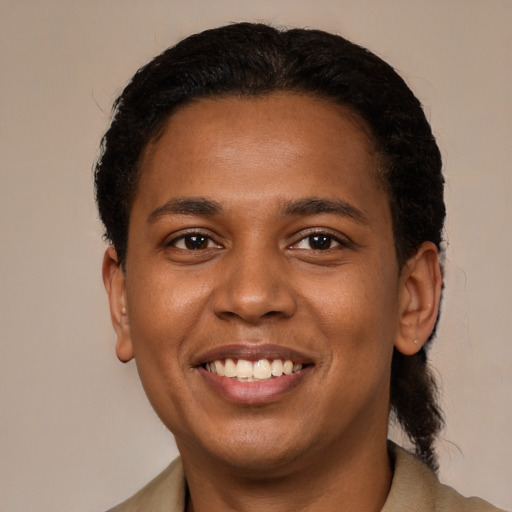 Joyful black young-adult male with short  brown hair and brown eyes