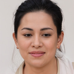 Joyful latino young-adult female with medium  brown hair and brown eyes