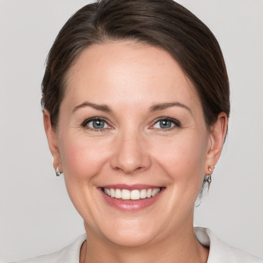 Joyful white adult female with short  brown hair and grey eyes