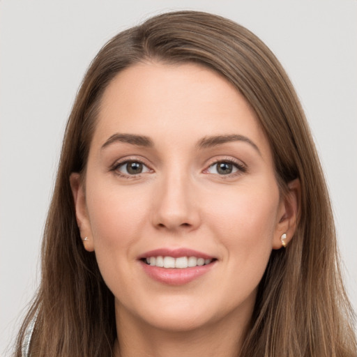 Joyful white young-adult female with long  brown hair and grey eyes