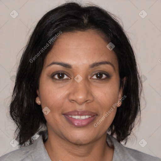 Joyful black adult female with medium  brown hair and brown eyes