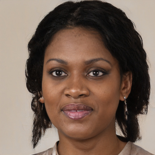 Joyful black adult female with medium  black hair and brown eyes