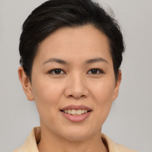 Joyful asian young-adult female with short  brown hair and brown eyes