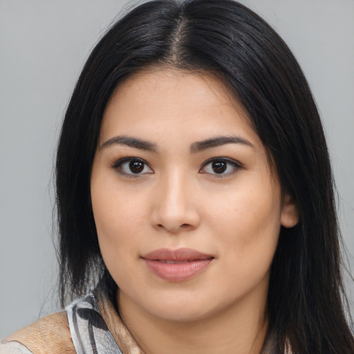 Joyful asian young-adult female with long  brown hair and brown eyes