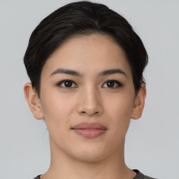 Joyful asian young-adult female with short  brown hair and brown eyes