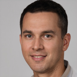 Joyful white adult male with short  brown hair and brown eyes