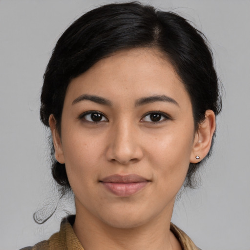 Joyful latino young-adult female with medium  brown hair and brown eyes