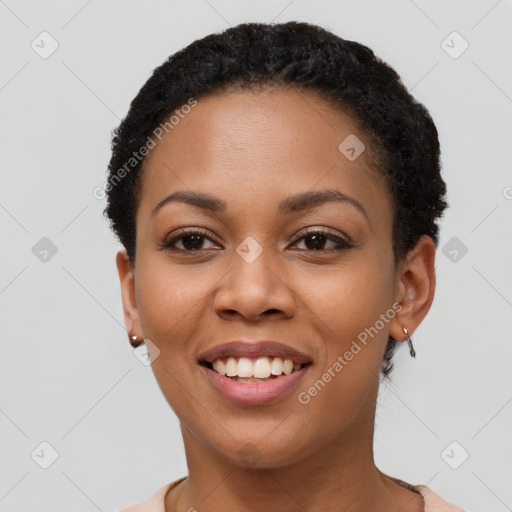 Joyful black young-adult female with short  black hair and brown eyes