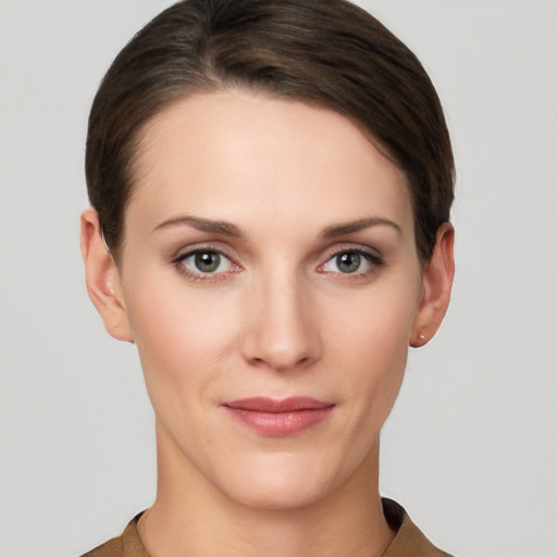 Joyful white young-adult female with short  brown hair and grey eyes