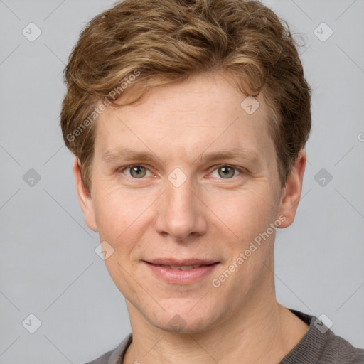 Joyful white adult male with short  brown hair and grey eyes