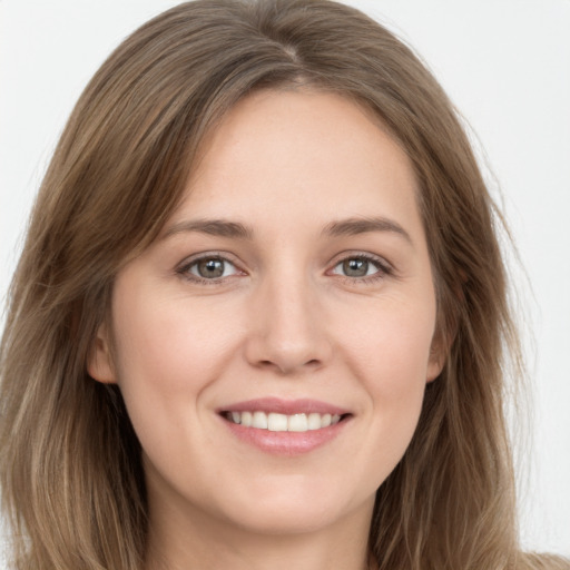 Joyful white young-adult female with long  brown hair and brown eyes