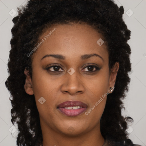 Joyful black young-adult female with long  brown hair and brown eyes