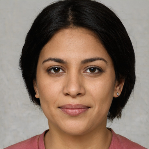 Joyful latino young-adult female with short  black hair and brown eyes