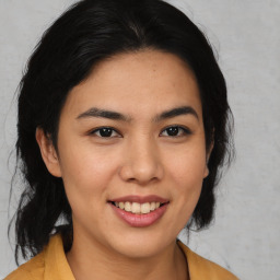 Joyful latino young-adult female with medium  brown hair and brown eyes