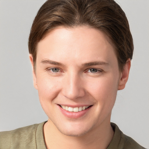 Joyful white young-adult female with short  brown hair and grey eyes