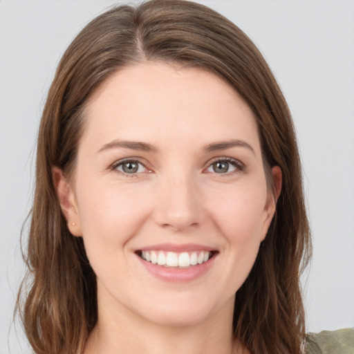 Joyful white young-adult female with medium  brown hair and grey eyes