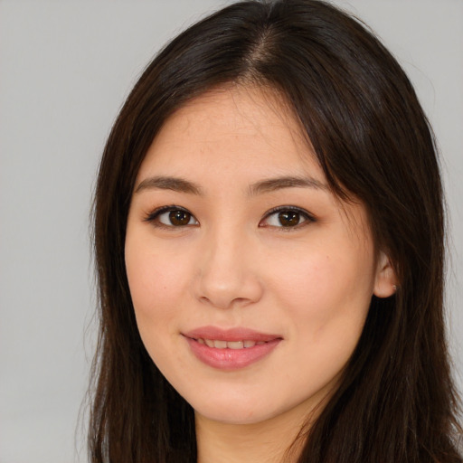 Joyful asian young-adult female with long  brown hair and brown eyes