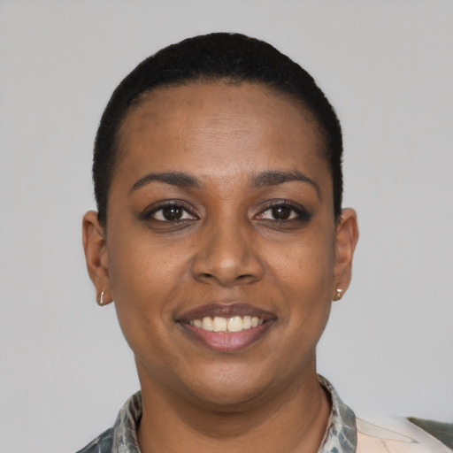 Joyful black young-adult female with short  black hair and brown eyes
