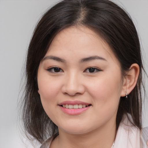 Joyful white young-adult female with medium  brown hair and brown eyes
