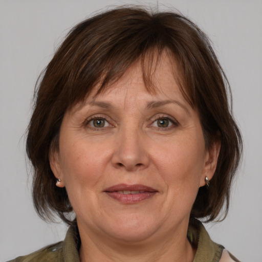 Joyful white middle-aged female with medium  brown hair and brown eyes