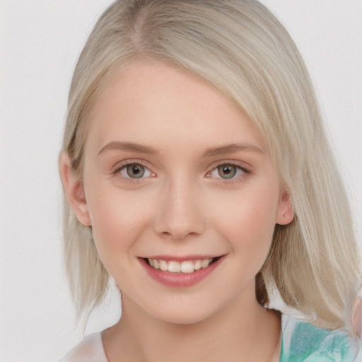 Joyful white young-adult female with medium  blond hair and blue eyes