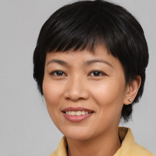 Joyful asian young-adult female with medium  black hair and brown eyes