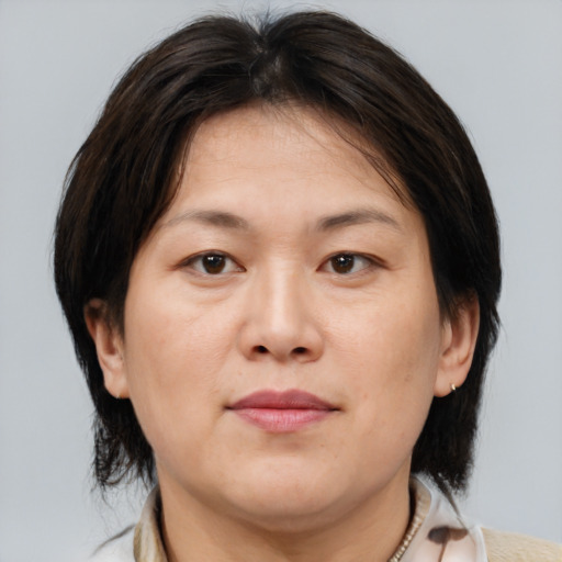 Neutral asian adult female with medium  brown hair and brown eyes
