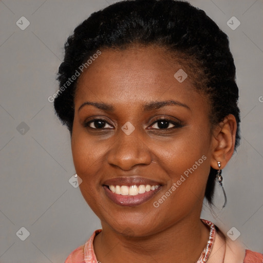 Joyful black young-adult female with short  brown hair and brown eyes