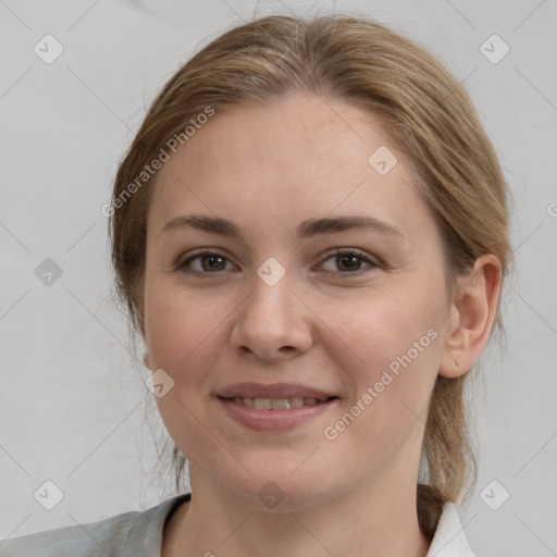 Joyful white young-adult female with medium  brown hair and grey eyes