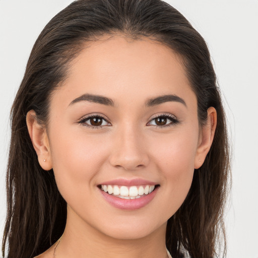 Joyful white young-adult female with long  brown hair and brown eyes