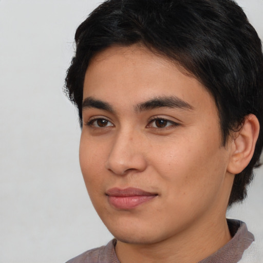 Joyful asian young-adult male with medium  brown hair and brown eyes
