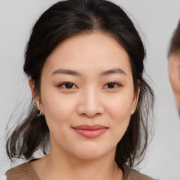 Joyful asian young-adult female with medium  brown hair and brown eyes