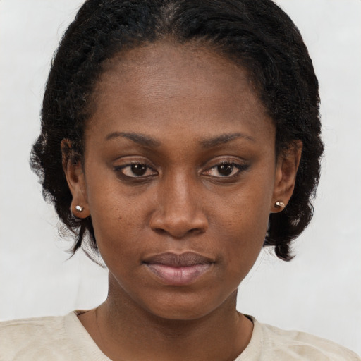 Neutral black young-adult female with medium  brown hair and brown eyes