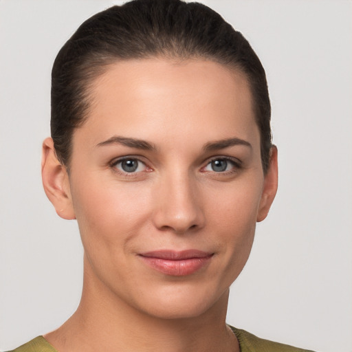 Joyful white young-adult female with short  brown hair and grey eyes